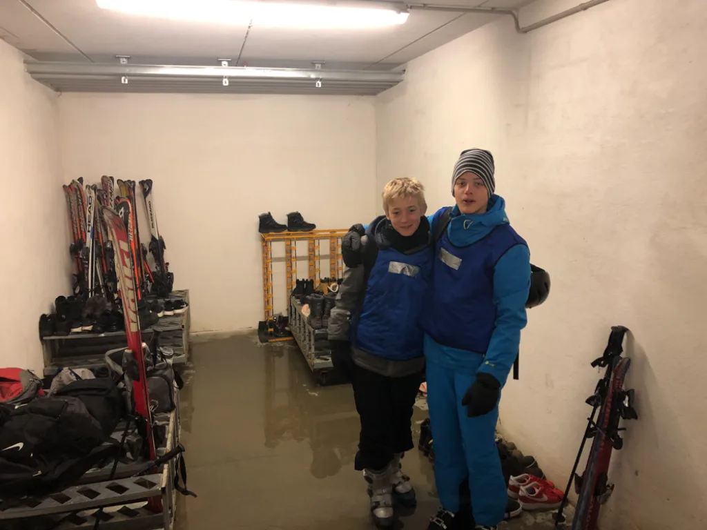 Zwei Personen stehen zwischen den Skiständern im Depot.